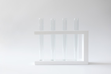Empty clean test tubes in rack on white background with copy space. Concept laboratory research and scientific experiment