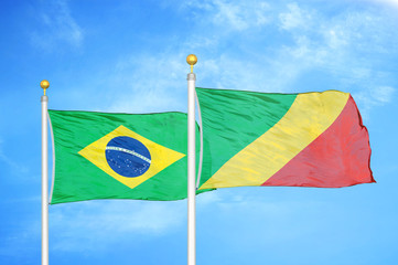 Brazil and Congo two flags on flagpoles and blue cloudy sky