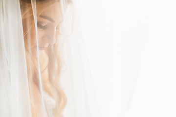 the bride closed her eyes and tulle in the foreground. profile.