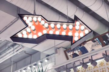 Retro arrow with lights points to the right.