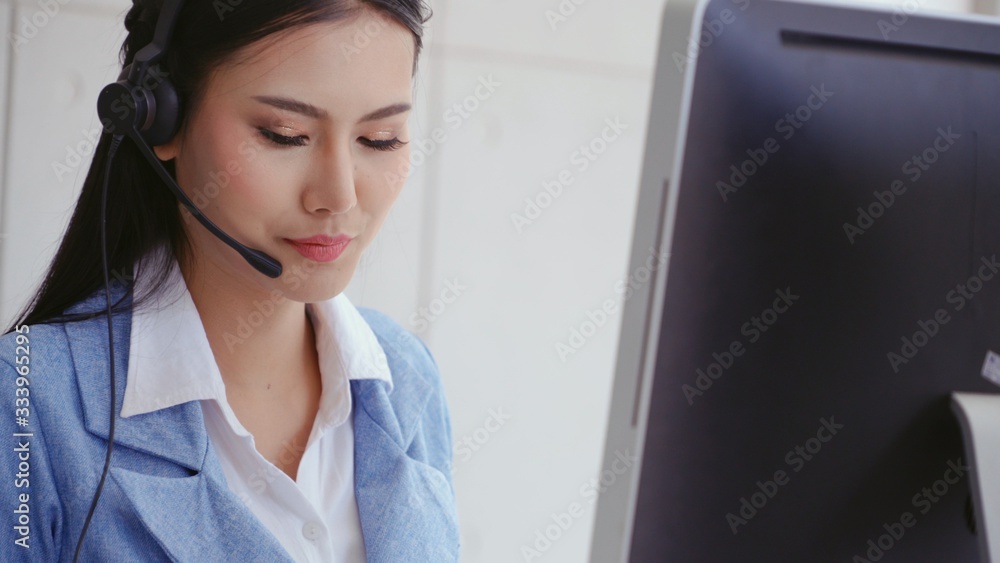 Aufkleber customer support agent or call center with headset works on desktop computer while supporting the cu