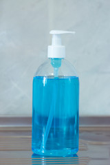 Liquid hygienic soap of blue color. Coronavirus prophylaxis, hand sanitizer. Hygiene concept.