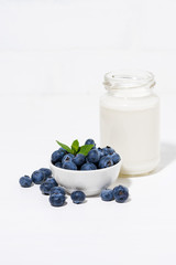fresh blueberries and a bottle of milk, vertical