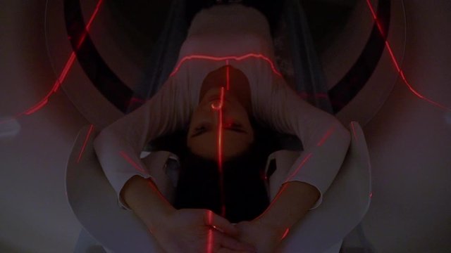 Red rays scan a girl on computed tomography CT scan of the abdomen for a woman to cure appendicitis, inter-intestinal abscesses, tumors, cysts, abdominal aortic aneurysm, blood clots of the abdominal