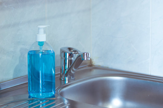 Liquid hygienic soap of blue color. Coronavirus prophylaxis, hand sanitizer. Hygiene concept.