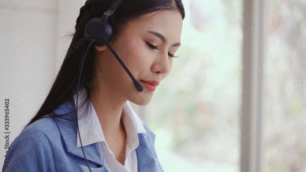 Aufkleber customer support agent or call center with headset works on desktop computer while supporting the cu