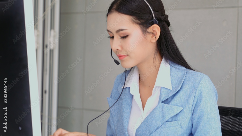 Aufkleber customer support agent or call center with headset works on desktop computer while supporting the cu