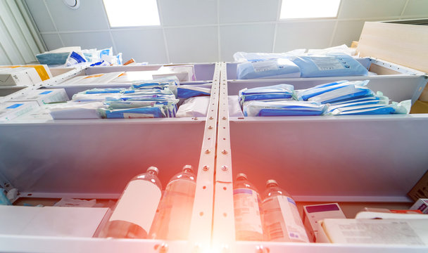 Stocked Shelves Of Medical Scrubs In Storeroom. No People. Scrubs, Medical Masks, Antiseptic, Health Care And Prevention Methods. Sanitizer. COVID-19 And Coronavirus Identification. Pandemic.