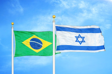 Brazil and Israel two flags on flagpoles and blue cloudy sky