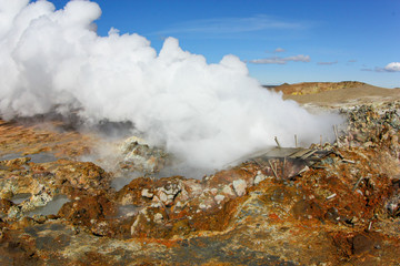 Steaming earth in Iceland. The exit of surface pair, an active geyser