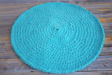 Turquoise knitted round carpet or rug. Antique handmade carpet. Home hobby.