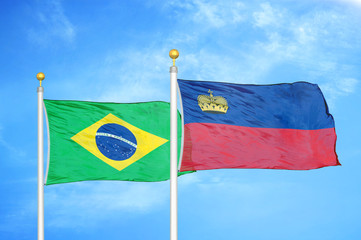 Brazil and Liechtenstein two flags on flagpoles and blue cloudy sky