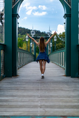 Girl crossing a bridge.