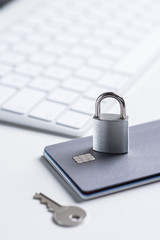 Finance. Security. Bank card with lock and key on a white table. Data security