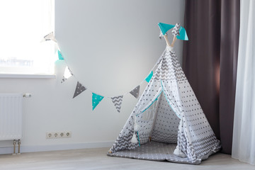 Children Tepee In Baby Room Wallpaper Background. Contemporary Preschooler Playroom Kid Toys Decoration Nursery Furniture Elements. Comfortable Childish Wigwam Arrangement Modern Apartment