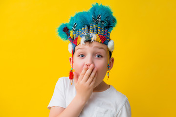 little boy in an Indian costume on a yellow background