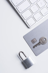 Finance. Security. Bank card with lock and key on a white table. Data security