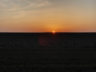 plowed soil. spring field. sunset over ploughed field. Countryside lanscape