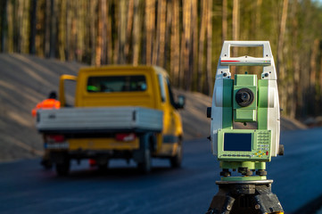 Surveyors equipment (theodolite or total positioning station) on the construction site of the road...