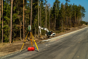 Surveyors equipment (theodolite or total positioning station) on the construction site of the road...