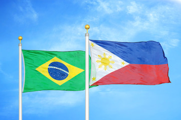 Brazil and Philippines two flags on flagpoles and blue cloudy sky