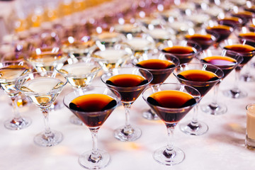 different types of glasses and alcoholic beverages on the table.