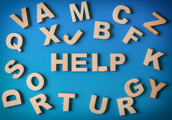 Background Of White Wooden Letters On A Blue Cardboard With Help Word