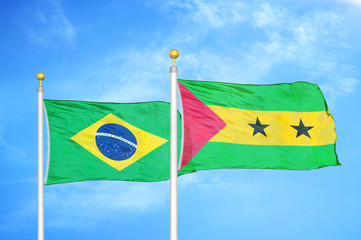 Brazil and Sao Tome and Principe two flags on flagpoles and blue cloudy sky