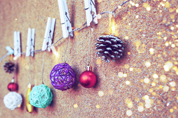 Christmas and New Year decoration with a garland on a beige wall background, shallow depth of field.