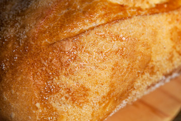 Texture of bread made from wheat flour with a delicious gold crust close-up. Photo of food.