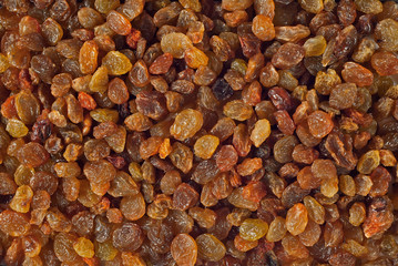 Texture of yellow and orange raisins. Dry raisins on the pile.