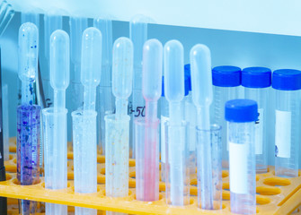 Scientific background with buffer solutions in glass bottles and liquid scientific or medical...