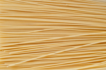 Pasta texture. Many yellow pasta are piled on the pile.