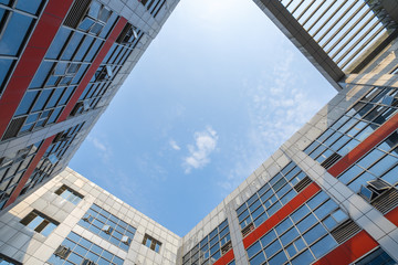 Looking up at the glass facade of a skyscraper