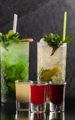 drinks with different fresh fruits in different glasses
