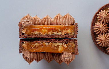 Two halves of tart with caramel and nuts