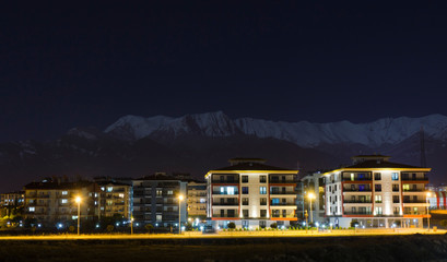 night view of the apartments with the snowy mountains background