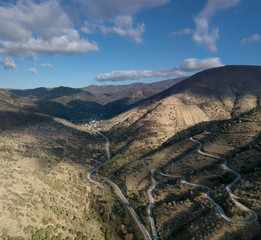 cloudy sky and narrow mountain road