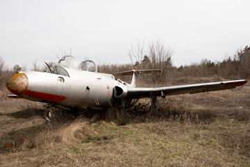 Old abandoned plane outside in autumn