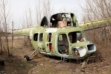 Old abandoned helicopter outside in autumn