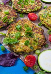 Zucchini pancakes with chives on a wooden table. - 333973274