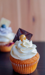 Single cupcake with caramel inside and cream ontop