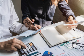 Stressed young couple checking bills, taxes, bank account balance and calculating expenses in the...