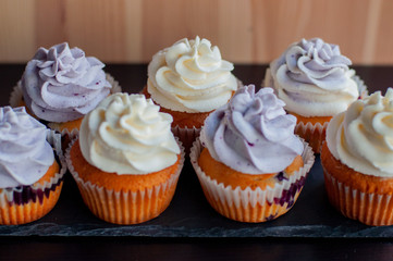 Colorful cupcakes with caramel inside and cream ontop