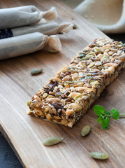 Superfood breakfast homemade bars with oats and seeds, on wooden background