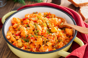 Vegetable stew with cauliflower in an enamel pan, selective focus