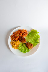 Fried chicken cutlet with potato slices served with tomato cherry and corn salad. Traditional belorussian food - roasted minced meat and potato