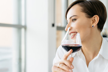 Happy smiling  woman drinking wine in the bar