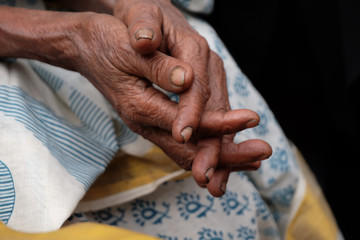 Fototapeta premium The hands of an old Indian woman, Kumrokhali, West Bengal, India