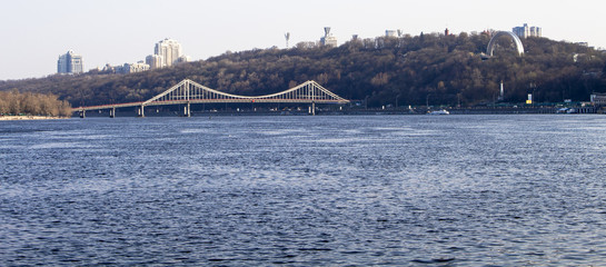 View from the river bank to the bridge and the city's hills